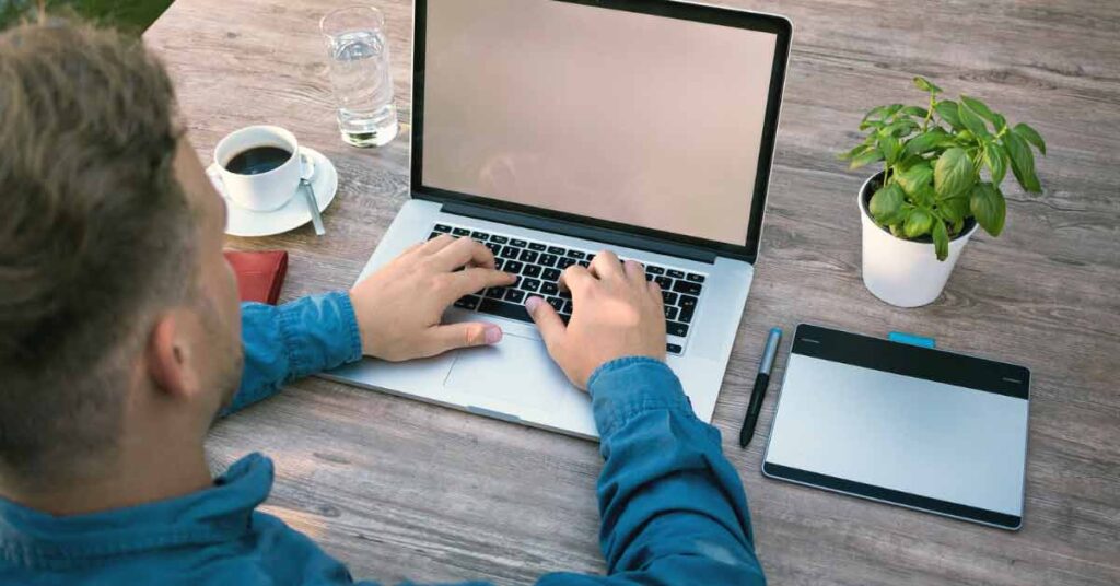 Man creating a website on laptop