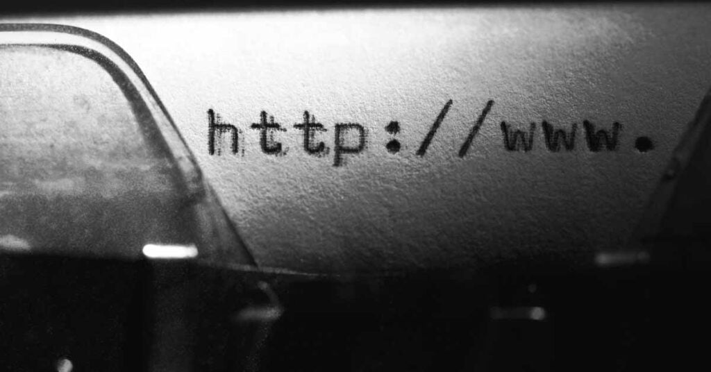 Typewriter with website domain typed on paper