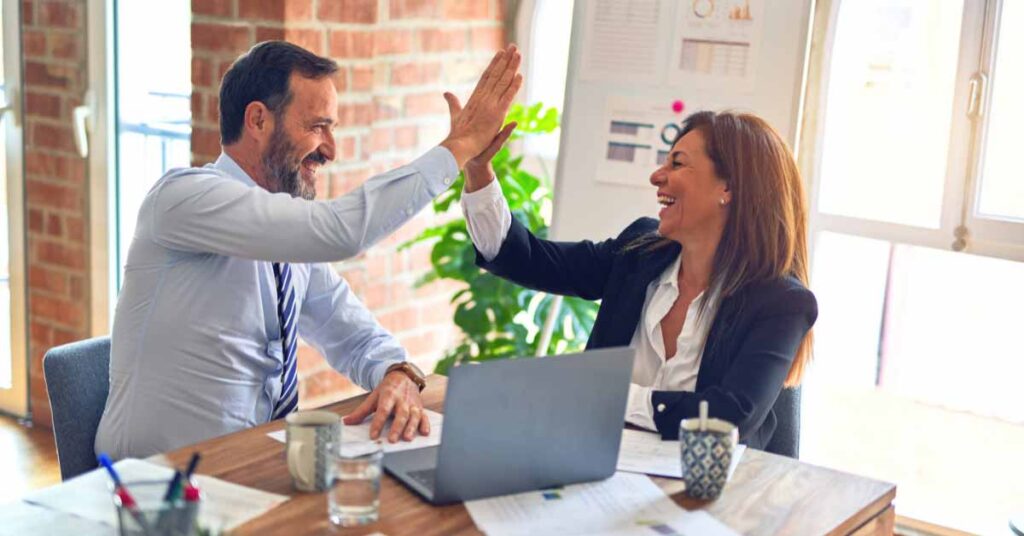 Image of a couple celebrating for figuring out web hosting costs