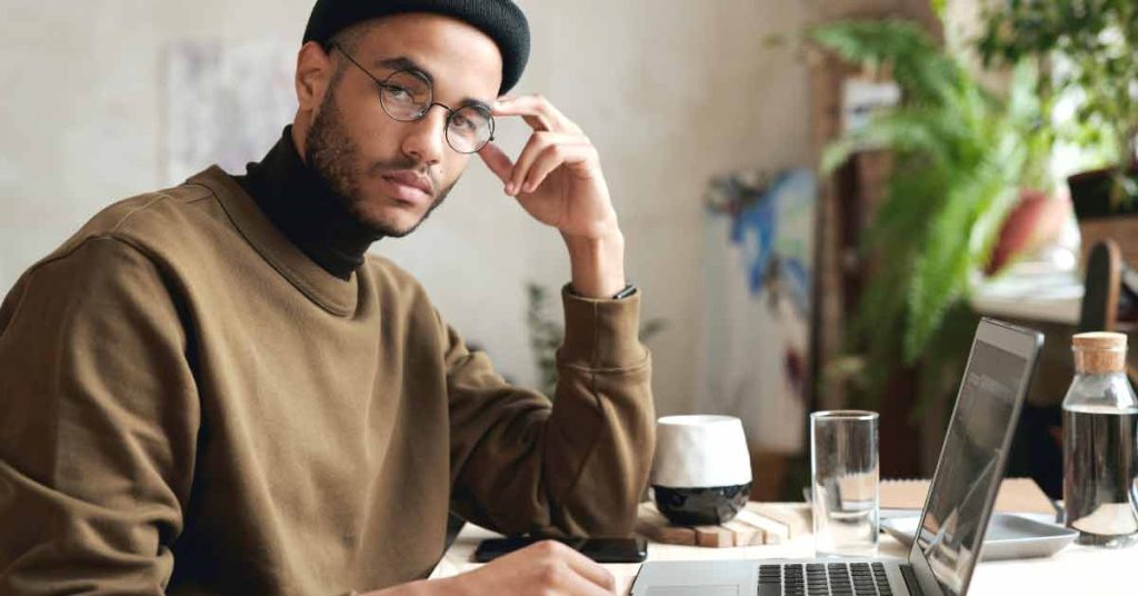 Image of UX designer working in on laptop