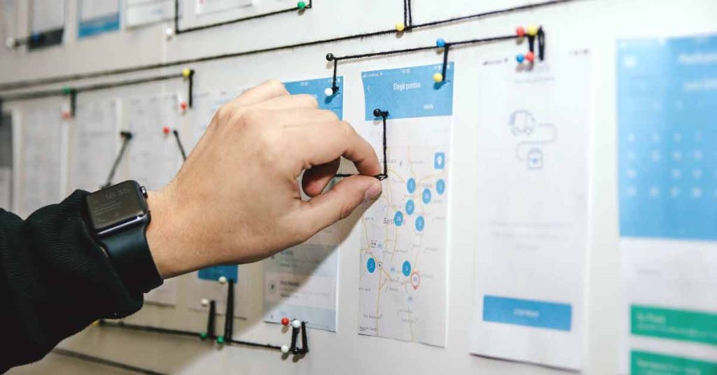 Image of designer mapping out user journey with wireframes