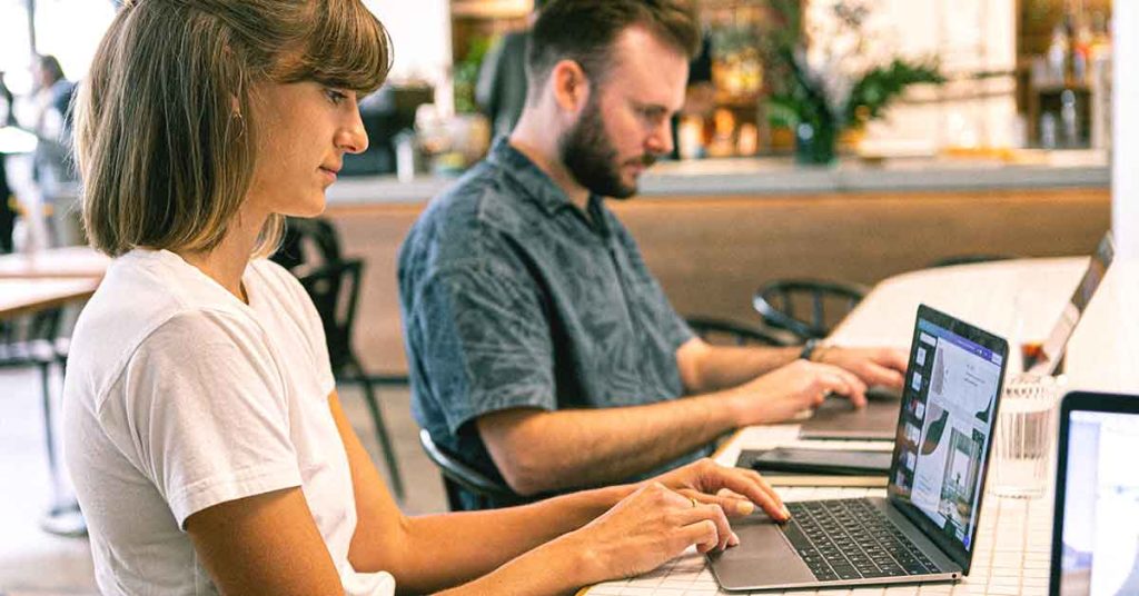 UX designer and UI designer working on laptops